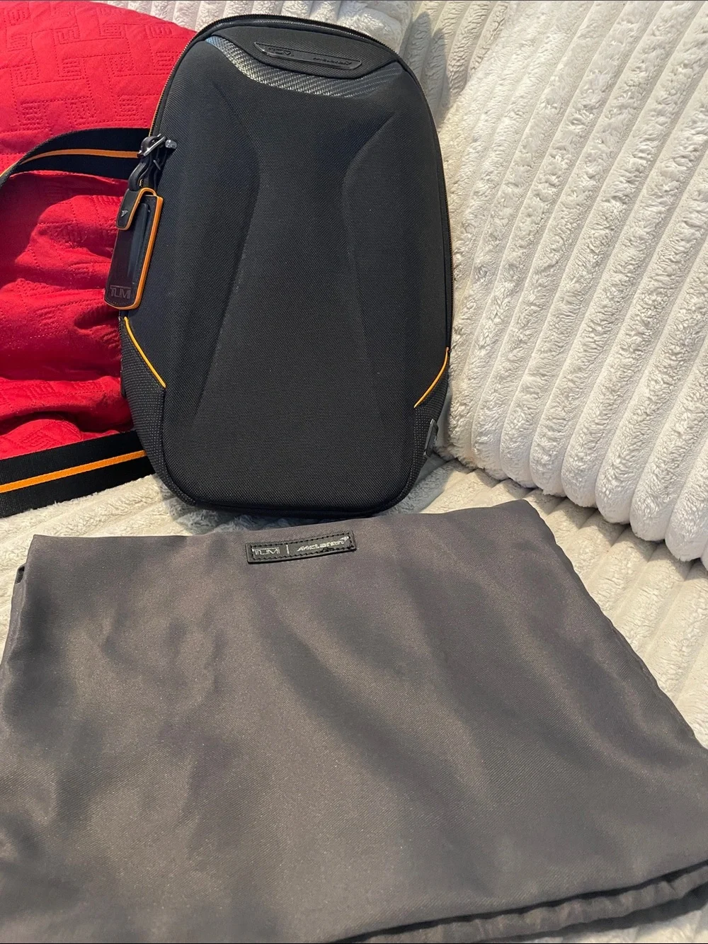 Tumi Black Sling Bag with Orange Accents